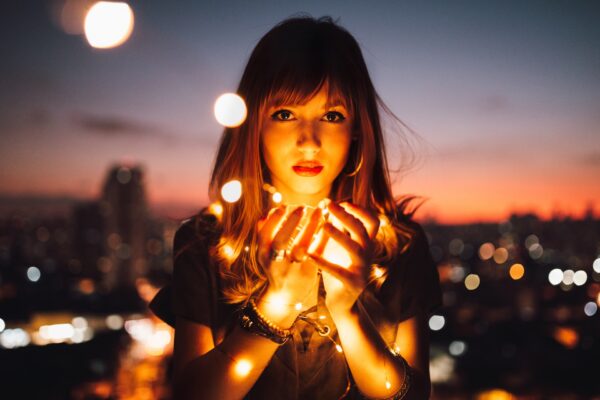 Photo of a girl holding light by Matheus Bertelli from Pexels